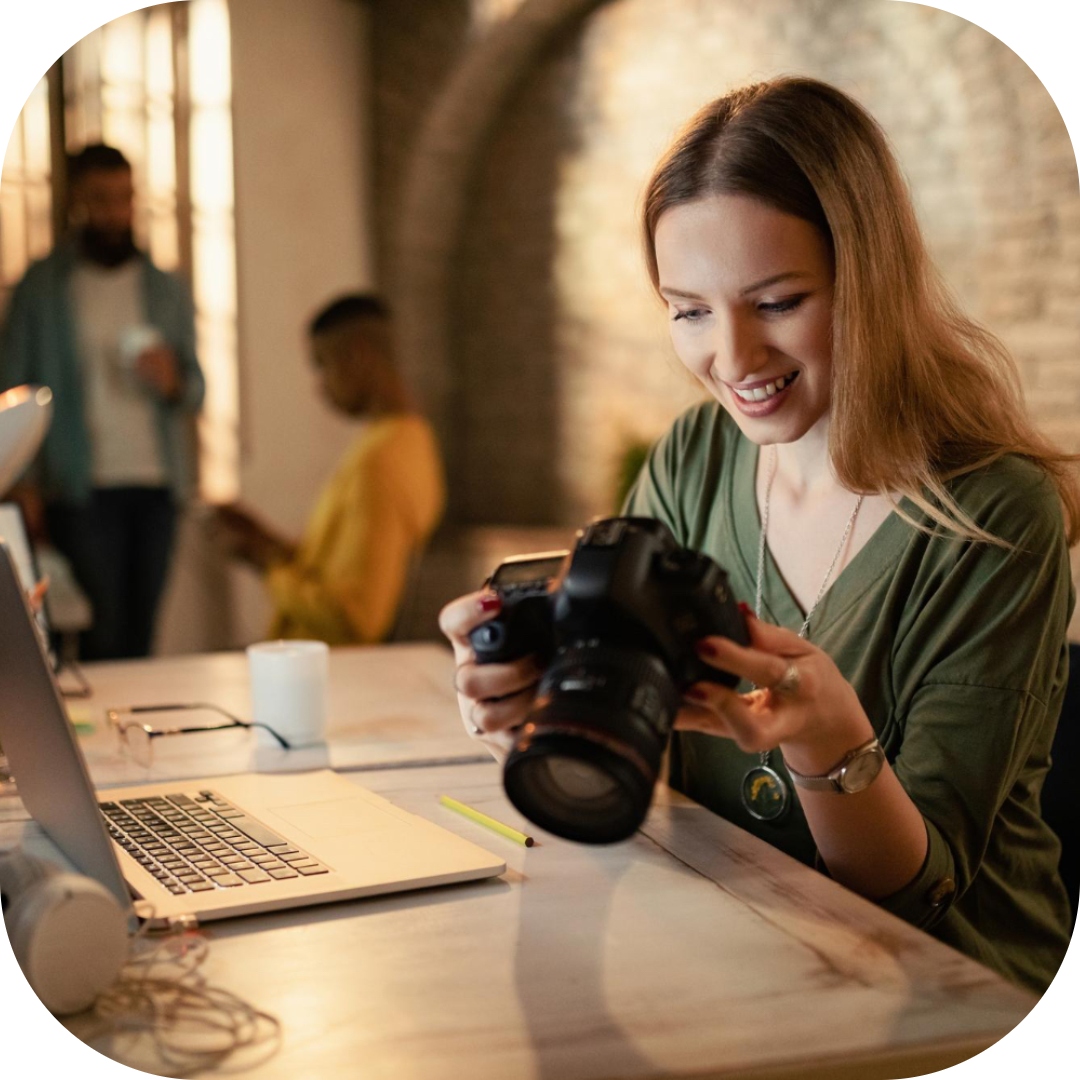 a woman photographer expressing happiness with the progress of her work
