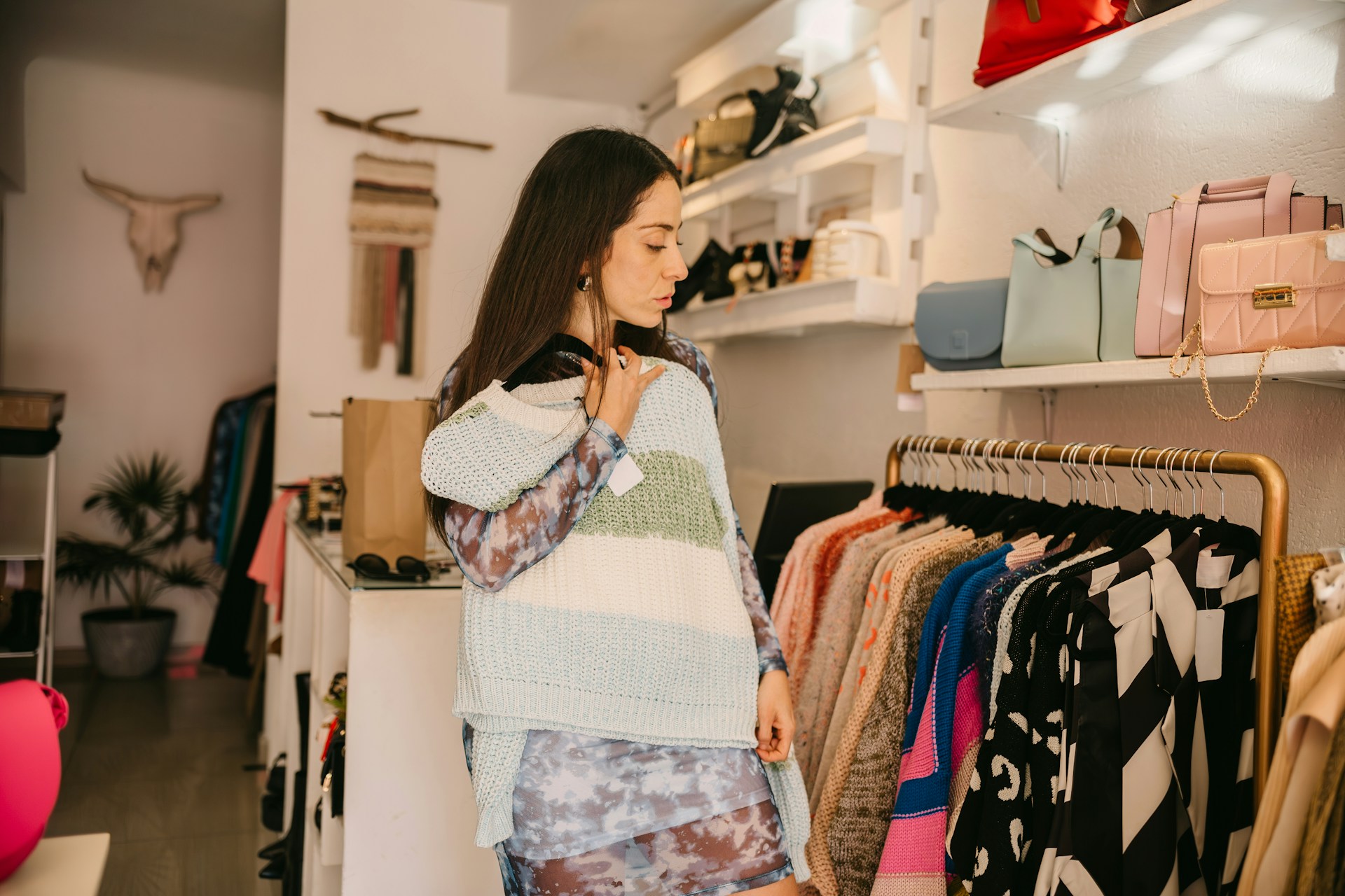 women looking for a sweater at a clothing store