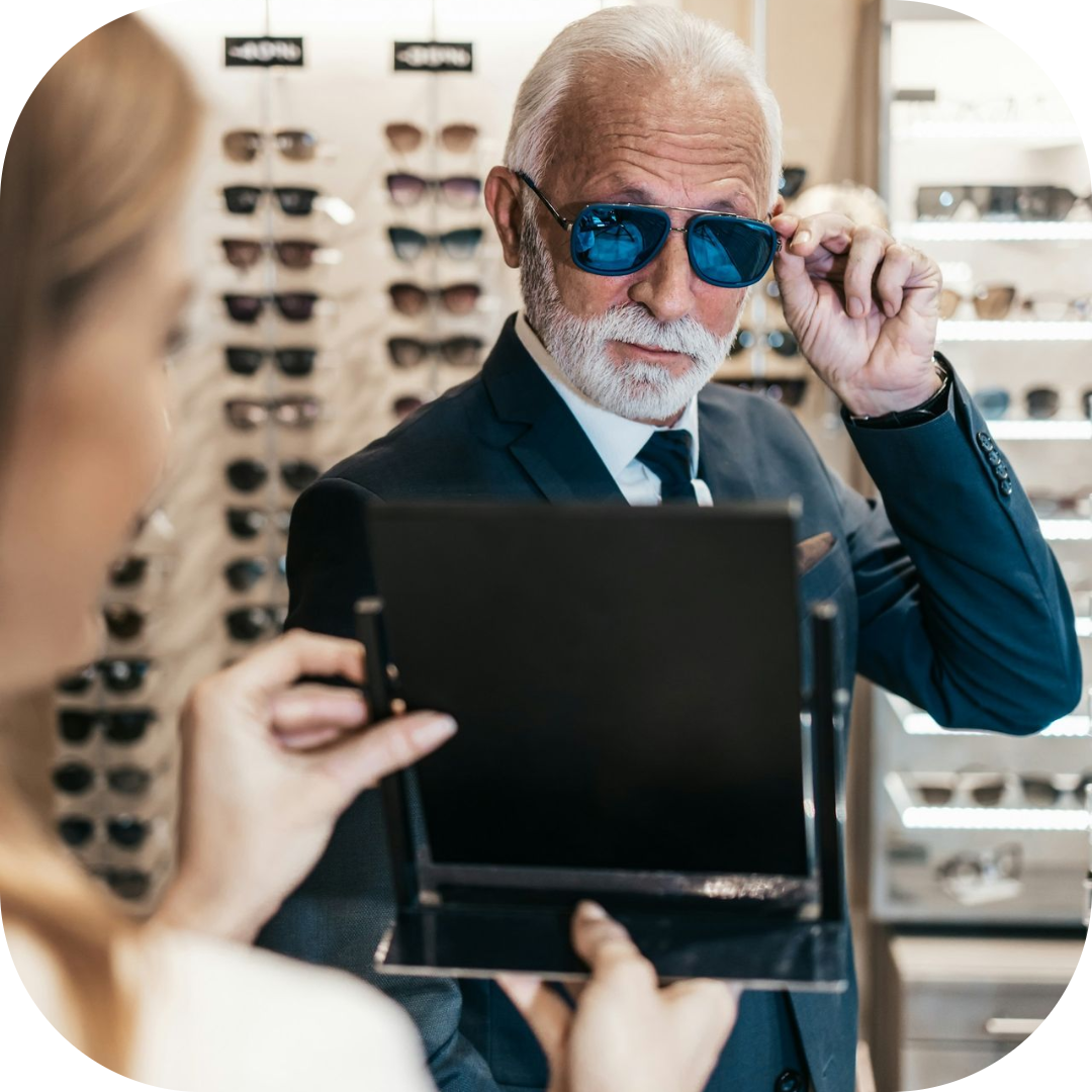 male customer trying on sunglasses with sales woman