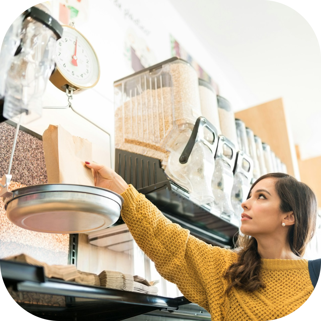 lady scaling her grains at the grocery store