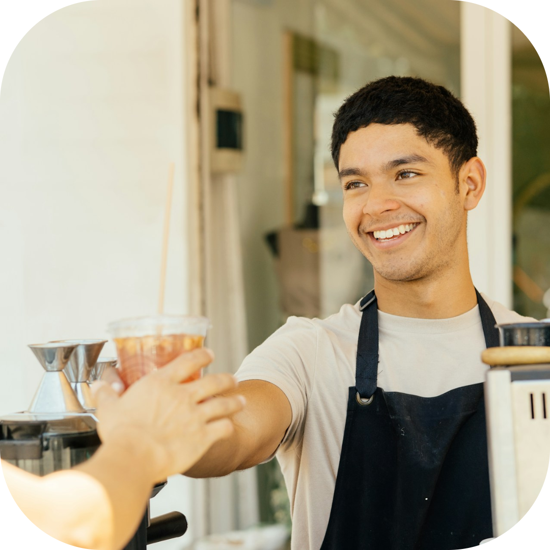 barista serving the customer their drink