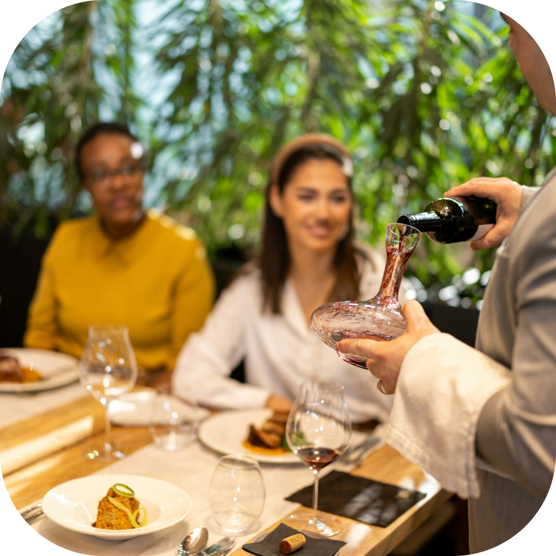 customers watching wine being poured