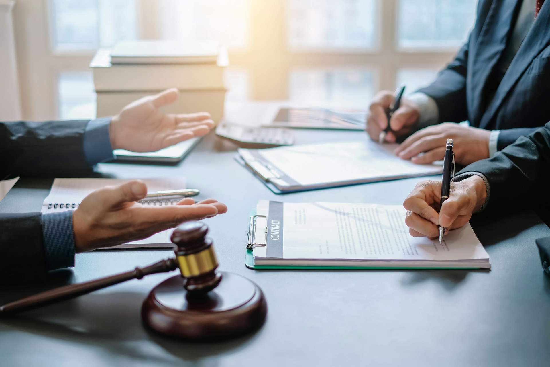 lawyers in the office signing contracts
