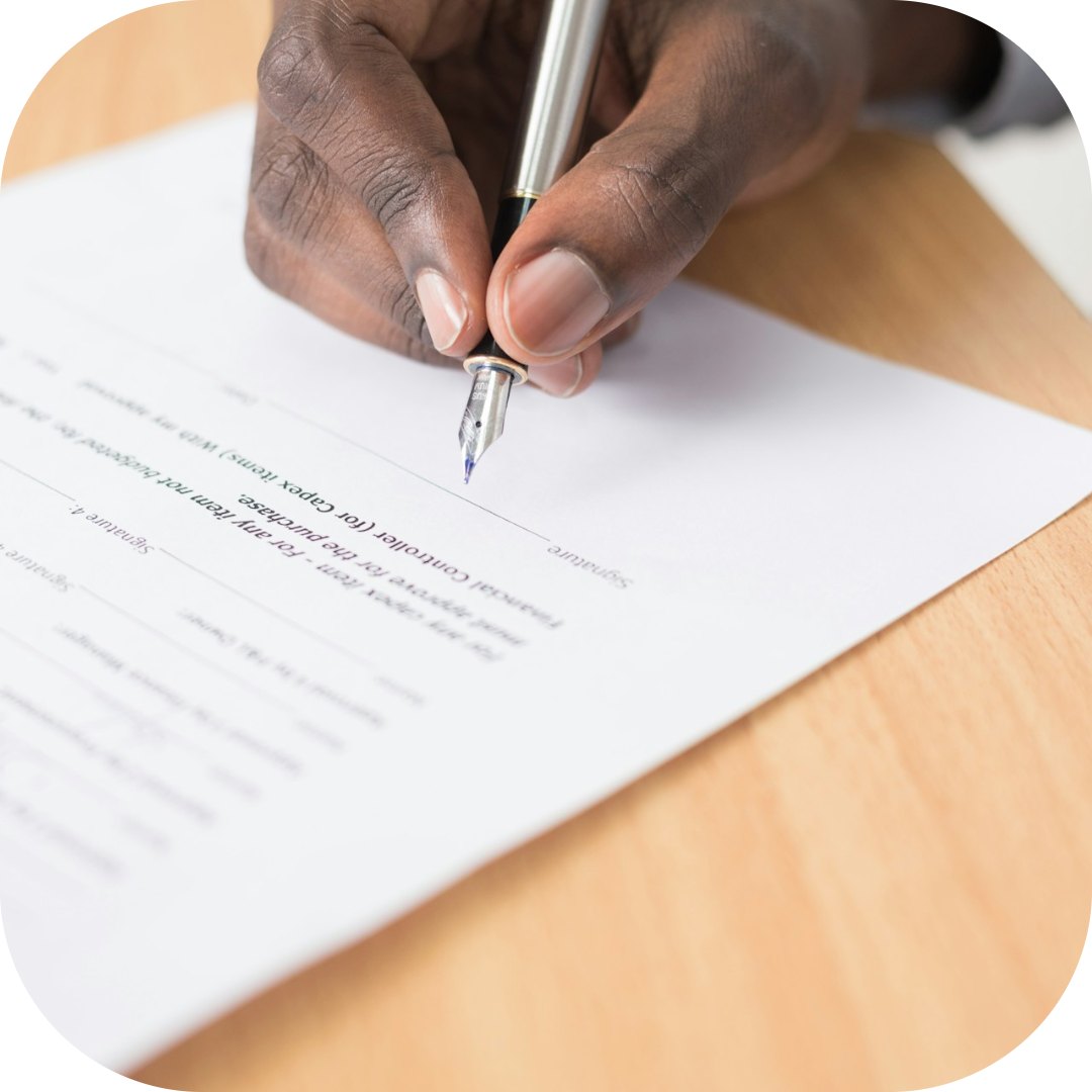 man signing documents