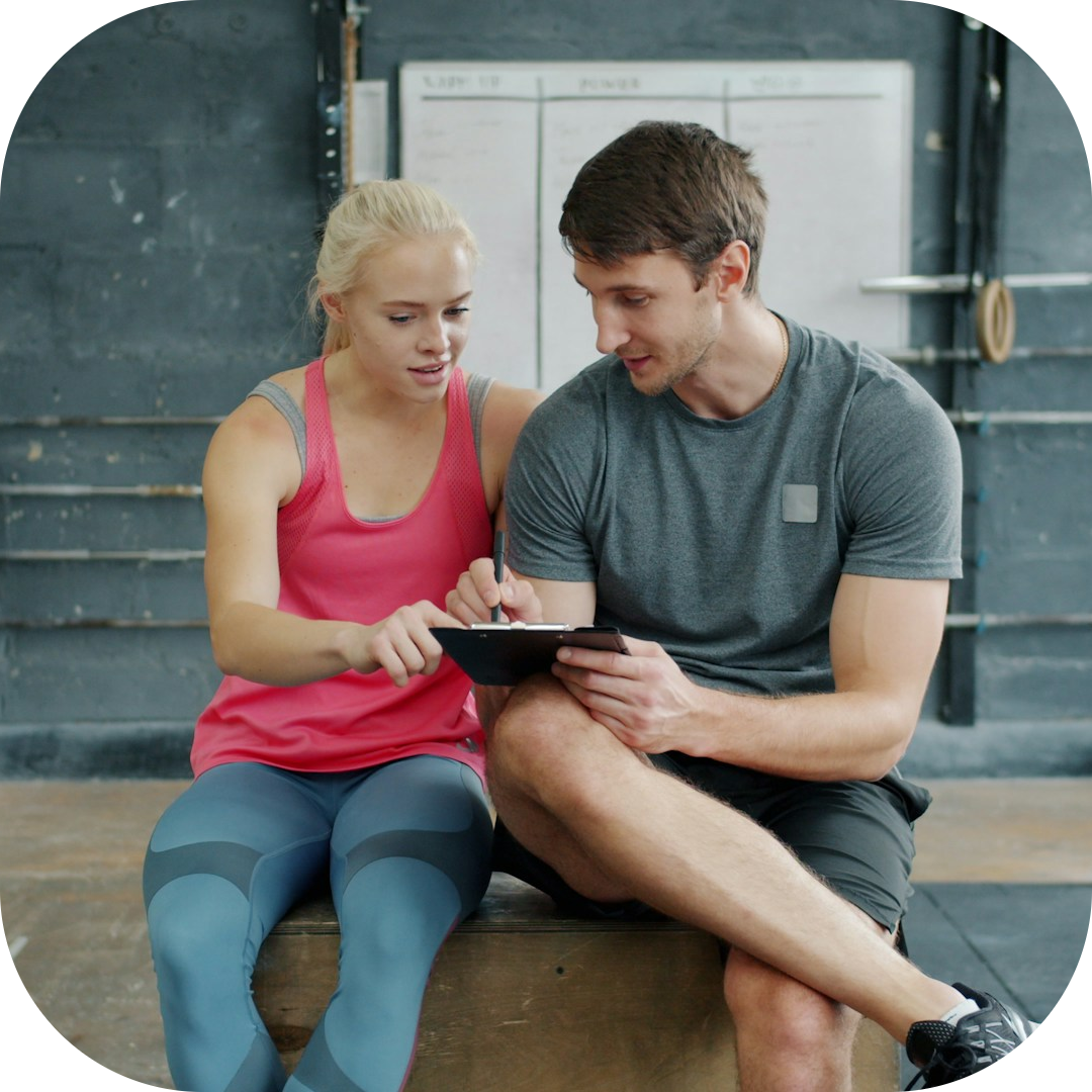 trainer and client in a discussion about the workout plan