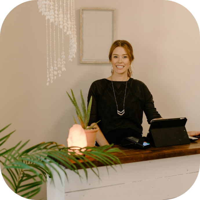 receptionist at the front desk greeting customers